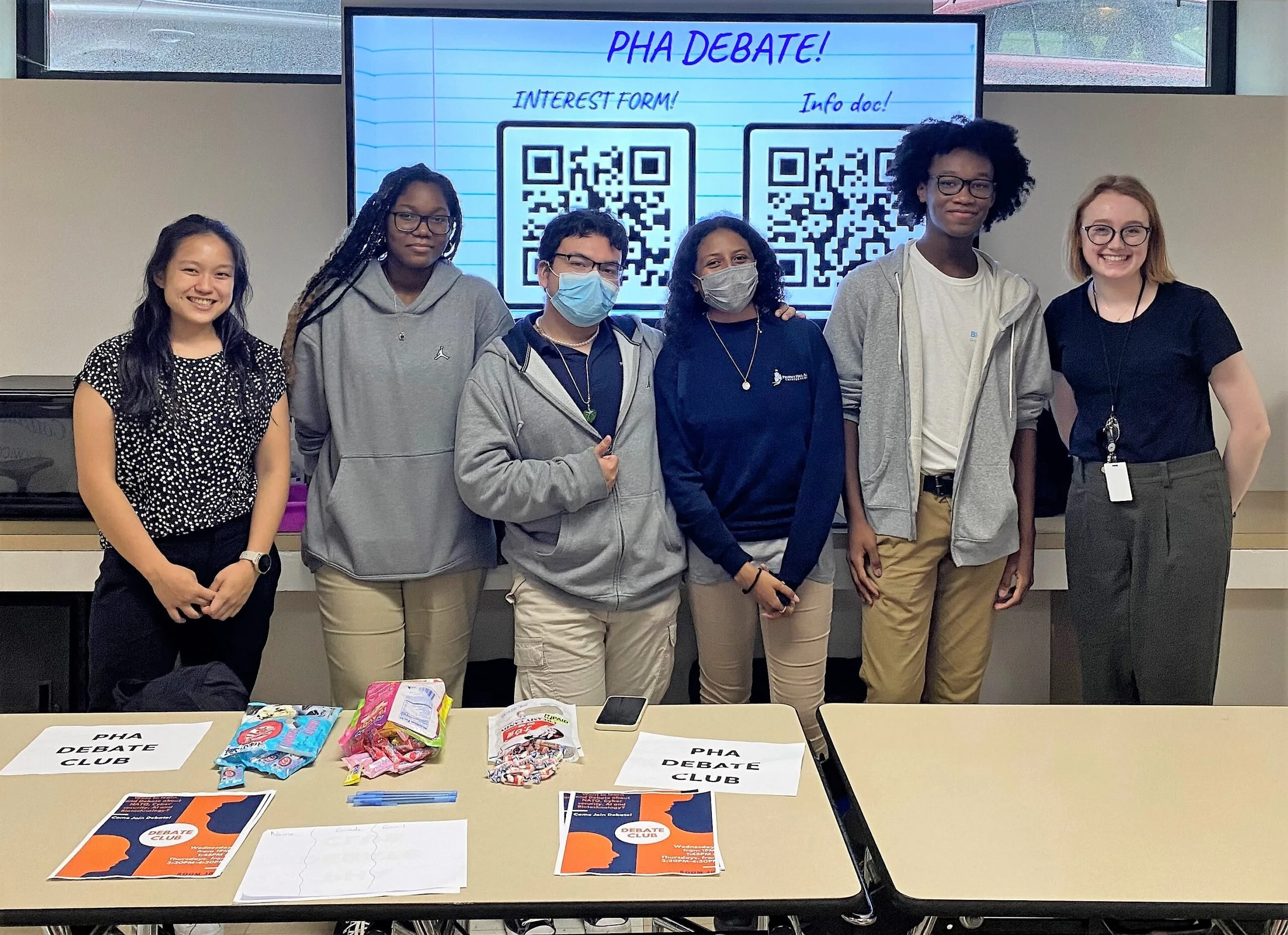 Two people smiling in lab coats